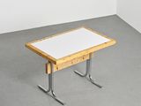 a white table with a wooden top in a room