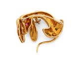 an image of a close up of a gold broochle with flowers