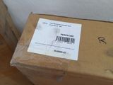a box with a label on it next to a pair of red shoes
