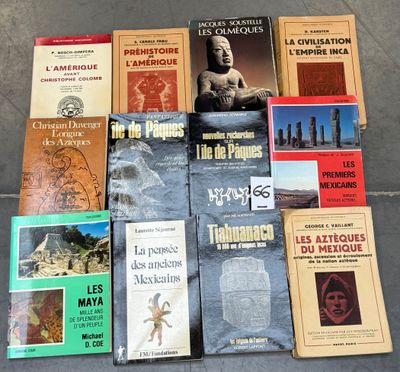 several books are stacked on top of each other on the ground