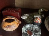 a shelf that has various glass items on it