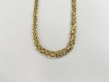 a gold chain necklace on a white background