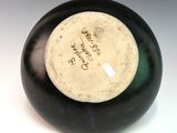 a black and white vase with writing on it