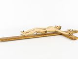 a statue of jesus laying on the cross on a white background