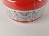 a red container with a lid on a white table