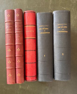 three books are lined up in a row on a table
