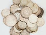 a pile of coins sitting on a white surface