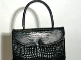 an image of a black purse sitting on top of a radiator