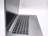 a silver laptop computer sitting on top of a white table