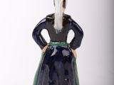 a figurine of a woman in a black dress
