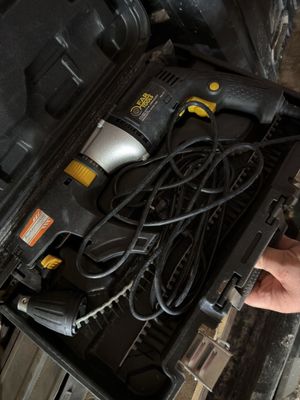 a person holding a drill in a tool box