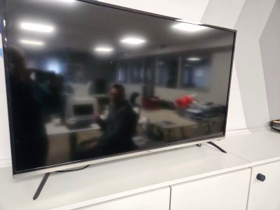 a flat screen tv sitting on top of a white entertainment center