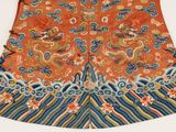 an orange and blue dress with a dragon design on it