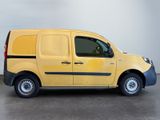 the yellow van is parked in a large room with a white wall