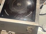 a stove top with a black burner on it in a kitchen