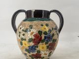 a small vase with flowers on it on a table
