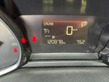 the dashboard of a car with a digital clock on it