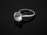 a close up of a diamond ring on a black surface
