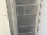 an open refrigerator that is sitting in the corner of a room