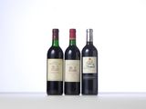 three bottles of wine are lined up on a table