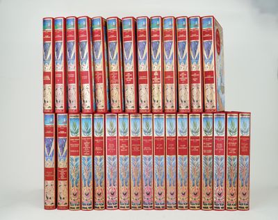 a lot of books stacked on top of each other