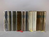 several books are lined up in a row on a table