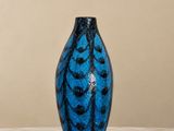 a blue vase sitting on top of a marble table