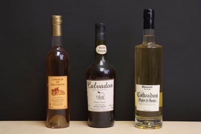 three bottles of wine sitting on a table next to each other