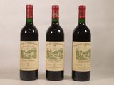 trois bouteilles de vin rouge posées côte à côte sur une table