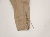 beige pants with laces on them on a white surface