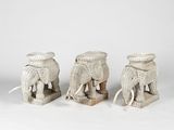 three white elephant figurines are sitting next to each other