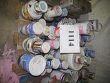 several cans of paint are stacked on a pallet with a price tag