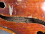 a close up of a violin neck with a label on it
