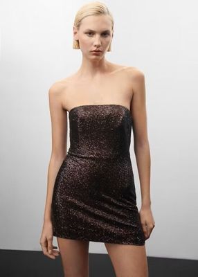 a woman in a short dress posing for a picture