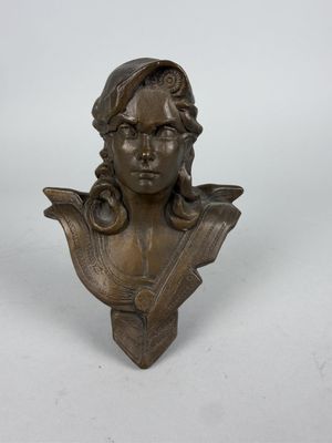 a bronze bust of a woman with long hair on a white background