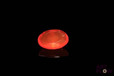 a red light in the dark with a black background