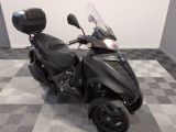 a picture of a black motorcycle parked in a room