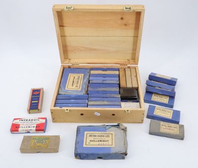 a wooden box filled with blue books and a box of matches