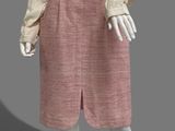 an image of a mannequin wearing a pink skirt and white shirt