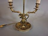 a brass candle holder with three candles on it
