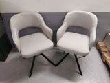 two chairs sitting next to each other in a room