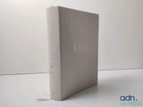 the front cover of a white book with a blue logo on it