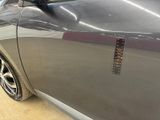 a close up of a car ' s side door with a sticker on it