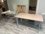 a table and two chairs in a room with wood flooring