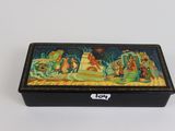 a black box with a painting on it sitting on a table