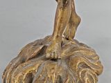 an image of a statue of a man on a rock