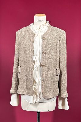 beige jacket on a mannequin stand against a red wall