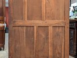 a very old wooden cabinet in the middle of a room
