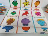 several children ' s books are lined up on a table
