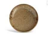 a brown plate that is sitting on a white surface